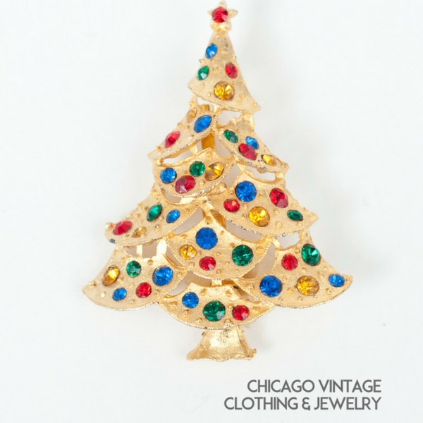 https://www.vintageclothingandjewelry.com/wp-content/uploads/2017/12/Vintage-Christmas-tree-pin-multiple-stones-green-red-blue-amber-pin..jpg